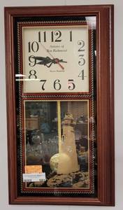 lot 581 image: FRAMED QUARTZ PENDULUM CLOCK WITH GOLD LIGHTHOUSE ON GLASS AS SHOWN.