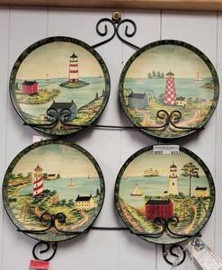 lot 613 image: SET OF 4 LIGHTHOUSE SCENE HAND PAINTED PLATES AND METAL RACK  HOLDER AS SHOWN.