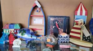 lot 640 image: BOAT SHELF WITH 2 DRAWERS, BANK, CANDLE HOLDERS, TEA LIGHT HOLDERS, WOOD SAILBOAT AND MORE AS SHOWN.
