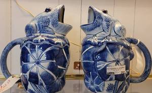lot 292 image: PAIR OF VINTAGE SEYMOUR MANN BLUE WHITE PORCELAIN SCARAB DESIGN FROG PITCHERS AS SHOWN. EACH MEASURES APPROX. 9 HIGH.