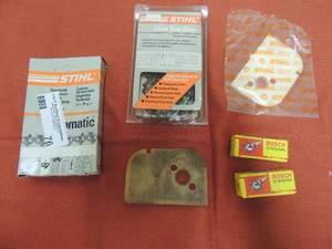 lot 76 image: Chain saw parts spark plugs new chair gasket and more