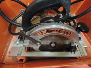 lot 102 image: Black & Decker circular saw in orange tool box carrier