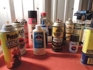 lot 112 image: Various cans of spray paint, motor oil, can of silicone, chalk, water repellent, belt dressing and more
