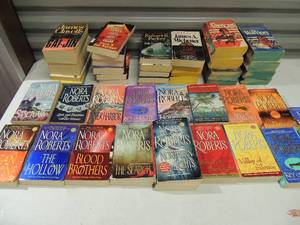 lot 207 image: Large lot of paperback books including entire set of Nora Roberts novels The Americans and The Warriors