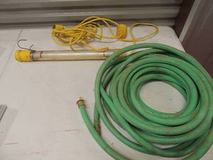 lot 239 image: water hose approx. 25 feet yellow halogen light with attached extension cord