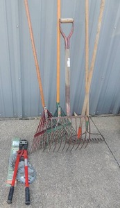 lot 247 image: Pitch forks and yard rocks bolt cutters and saw blades