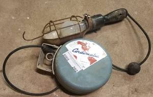 lot 202 image: VINTAGE CARDOMATIC PORTABLE LIGHT WITH CORD REEL AS SHOWN.