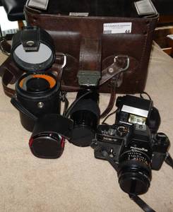 lot 44 image: VINTAGE MINOLTA XE-7 35MM CAMERA WITH ADDITIONAL LENSES, FLASH, AND CASE AS SHOWN.