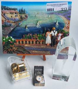lot 513 image: ASSORTED DECOR PIECES INCLUDING FRAME WITH STAND, MUSIC BOX TRINKET CLOCK BOX AND MORE AS SHOWN.