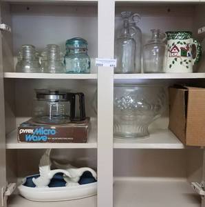 lot 651 image: CONTENTS OF CABINETS INCLUDING VINTAGE GLASS INSULATORS, VINTAGE GLASS BOTTLES, PYREX MICROWAVE RING MOLD, AND MORE AS SHOWN.