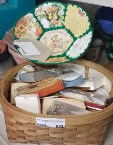 lot 653 image: BASKET LOT OF VINTAGE HAND MADE GIFT BOXES AND SUCH WITH INSTRUCTIONSPATTERN HOW TO MAKE THEM. GIFT BOXES ARE MADE OUT OF CHRISTMAS CARDS.