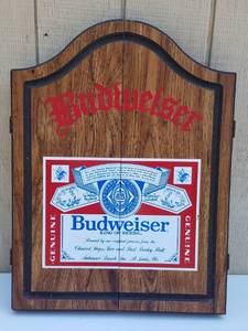 lot 765 image: VINTAGE CREST BRITANNIA DARTBOARD ENCASED IN A BUDWEISER CABINET AS SHOWN. MUST SEE