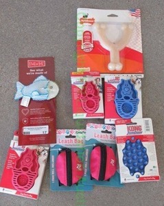 lot 17 image: Fluff and Tuff, Kong Zoom Groom, and Nylabone pet cleaning materials and chew toy