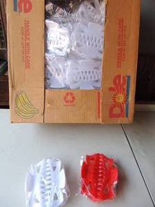 lot 161 image: 4 banana boxes of jumbo red and white new hair clips over 100 pieces