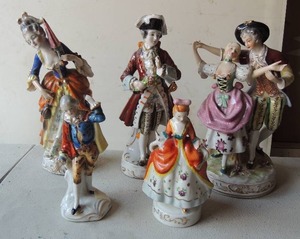 lot 173 image: Dancing men and woman figurines all from Occupied Japan 2 are 6 tall  man in red coat 9 tall  single lady 9  tall lady star man 9
