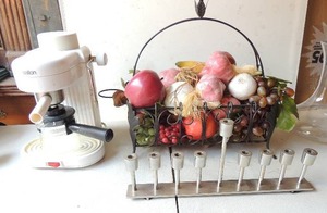 lot 175 image: Metal basket center piece, Salton single cup coffee maker, 9 tier candle holder, and clear glass vase