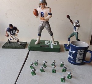 lot 176 image: Dallas Cowboy lot- Statue on green stand #8  TROY AIKMAN 11H   other 2 are 6 H  Official coffee cup and little cake dcor