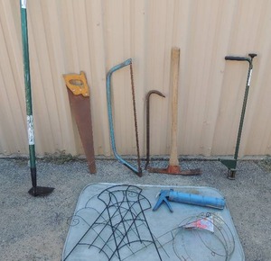 lot 180 image: Blue bow saw, weed hound, yard pick, yard hoe, floral yard guards, hand saw and caulking gun large drip pan