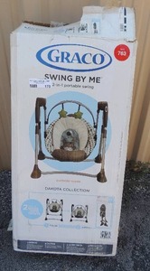 lot 182 image: Graco Swing by Me baby swing unknown condition appears to be new  in damaged box