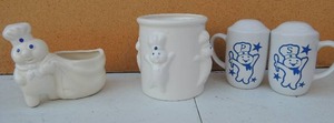 lot 218 image: Pillsbury Dough boy set of salt and pepper shakers, one jar no top and one sugar dish
