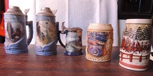 lot 257 image: Steins lot- 2 blue Longton crown, 1 mount Rushmore, 2 statue of liberty 3 Eagle of the last frontier by Ted Blaylock Franklin Mint, handcrafted Budweiser and 50th anniversary Nascar