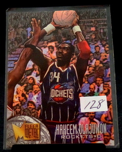 lot 128 image: 95-96 Fleer Metal Hakeem Olajuwon Basketball Card #154 Houston Rockets The Dream