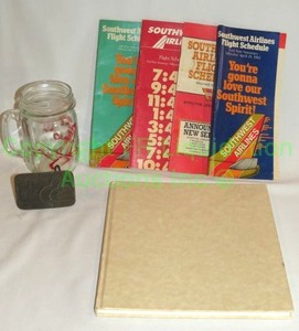 lot 140 image: Vintage Southwest Airlines collectibles including brass belt buckle, brochures and more