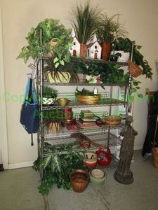 lot 512 image: Metro rack and contents of assorted artificial plants, planters, bird houses and more as shown