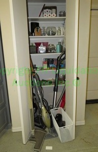 lot 438 image: Contents of utility closet including vacuums, vases and more as shown
