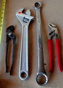lot 38 image: Large Adjustable Wrench, 1 116 Wrench, and 2 Plumbers Wrenches