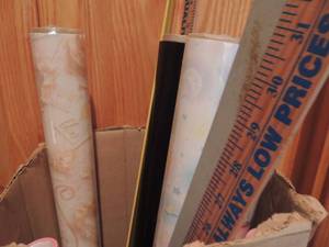 lot 113 image: Box full of yard sticks and wrapping paper
