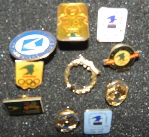 lot 333 image: Postal service lapel clips ( 10 total) Olympic pins x 2, 20th anniversary, 2nd yr., Rain nor sleet, safety 9 yr. and 11 yr., 250 hrs., 1000 sick leave
