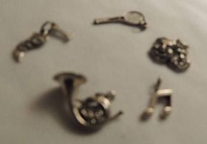 lot 373 image: Charms x 4 - French horn, tennis racket, music notes, comedy tragedy masks