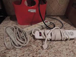 lot 105 image: Red bucket full of extension cords with multiple plugs