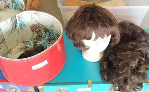 lot 232 image: Red hat box full of wigs