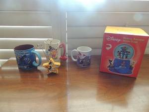 lot 19 image: NIB Disney musical Birthday snow globe, Nemo coffee cup and 6 flags coffee cup