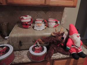 lot 212 image: Suitcase full of Christmas dcor, tins, mugs,stuffed animals