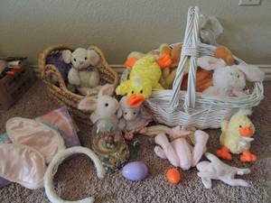 lot 175 image: White wicker basket full of Easter beanies and snow globe and basket full of Easter bunnies