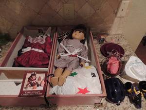 lot 173 image: AMERICAN GIRL DOLL - Samantha doll comes in carrying case has clothing, shoes, skates, dresser and hats