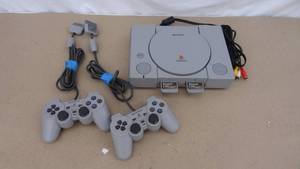 lot 135 image: Playstation (PS1) with 2 controllers