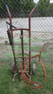lot 370 image: Drum carrier hand truck, drum pump, and locking drum lift tool