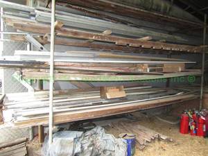 lot 139 image: Assorted wood and metals in racks as shown