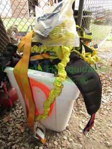 lot 229 image: 55 gallon storage can full of safety harnesses and shipping straps