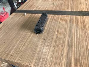 lot 271 image: Bar Table (W84 x D30 x H43 approx.) Laminate Finish, 2 Metal Straps, Heavy Steel Legs (4 and 3 square), 2 Electrical Hideaway Outlets