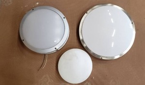lot 384 image: Ceiling Lights, Round Flush Mounts, and Outdoor Fixtures ( 3 Total), Large Grey one is Cast Metal and Waterproof for Outdoors, various Styles and Sizes