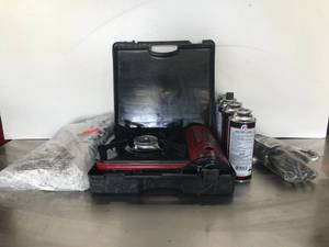 lot 235 image: Butane Burner, 4 cans butane, Unopened Pack of 12 Tongs, Ice Bags