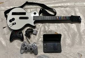 lot 111 image: Guitar Hero 2 Controllers & a Nintendo 30SXL Handheld game