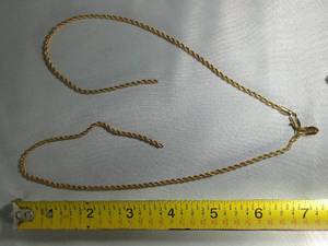 lot 58 image: BROKEN GOLD TONE NECKLACE  ENGRAVED LJ24KGL NOT TESTED