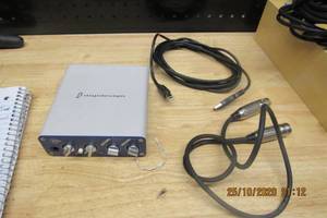lot 21 image: DIGI DESIGN COMPUTOR MINI BOX 2 RECORDING MODULE SERIAL BEAM- XO240273E, COMES WITH USB 2.0 CABLE, MIC CHORD, AND PRO TOOLS SOFT WARE