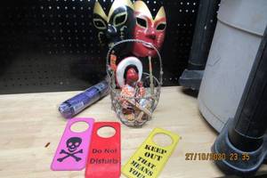 lot 161 image: HIS AND HERS HAND HELD PARTY MASKS, GIUSEPPE PUPPET, DOOR KNOB HANGERS, AND UMBRELLA IN A WIRE MESH BASKET
